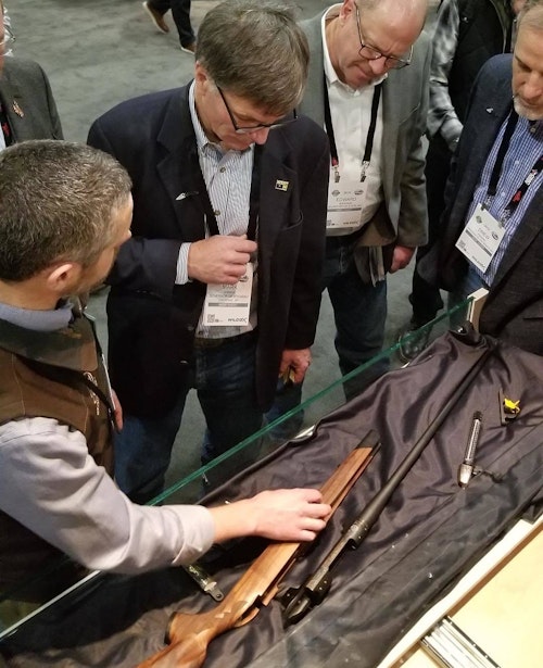 Wyoming Governor Mark Gordon talking with Adam Weatherby (left) about the Wyoming Commemorative Rifle at SHOT Show 2019.