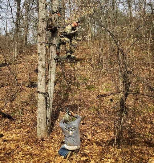 Bill Konway photographs a treestand from below. (Photo courtesy of Bill Konway.)
